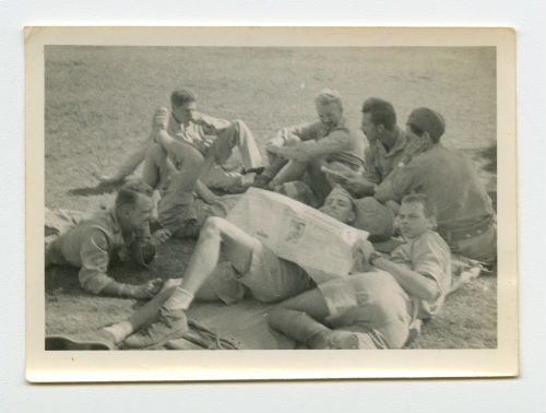 Men reading the newspaper in the Western Desert. Recto
