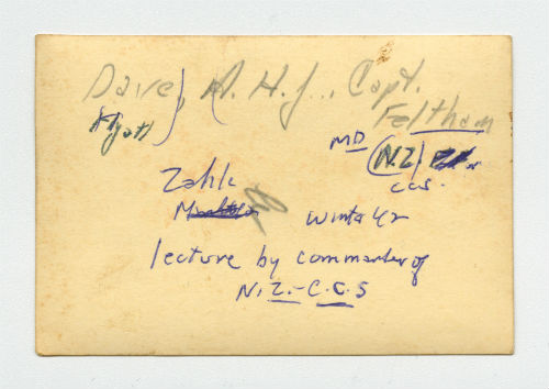 Dave Hyatt, Arthur Howe Jr. and Captain Feltham listening to a lecture. Verso