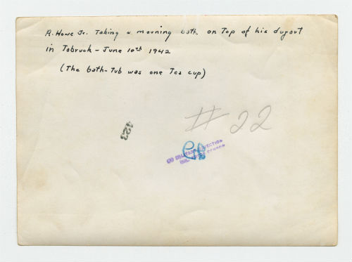 Arthur Howe, Jr. taking a morning bath on the top of his dugout in Tobruk, Libya. Verso 1