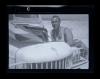 Arthur Howe, Jr. beside the front of a vehicle