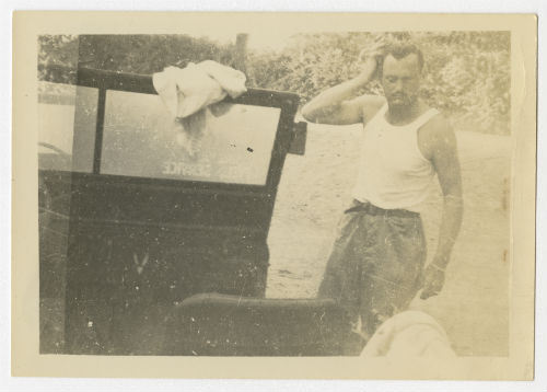 Charles "Charlie" Snead beside an AFS jeep