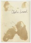 Charles "Charlie" Snead standing behind a vehicle. Verso
