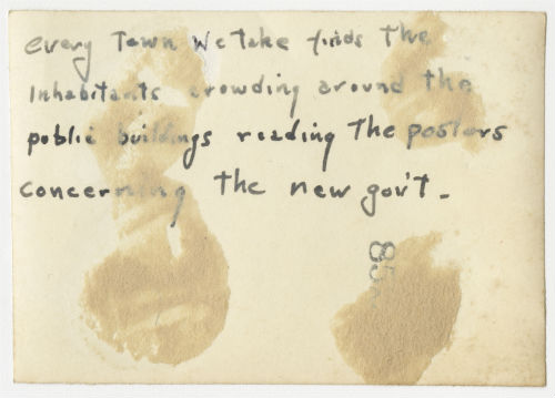 Crowd in front of a public building. Verso