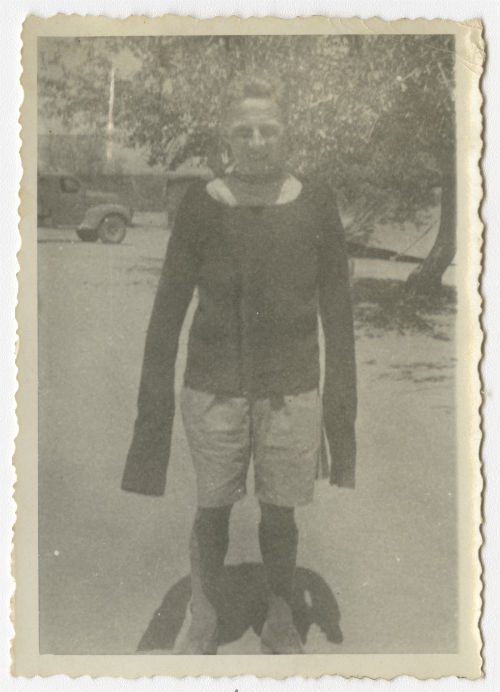 Hugh White wearing a sweater donated by the Detroit Ladies Club. Recto