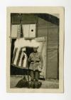 Walter Winthrop Gores, Sous Chef of SSU 70, standing with an American flag.