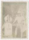 Unidentified individual and Bayard "Newport Nellie" King leaning against a milestone near Al-Swani