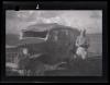 Unidentified individual standing beside an ambulance