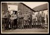 Men outside the barrack where chassis and motors were taken down and assembled