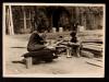 Two men sitting on planks