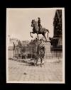 A. Piatt Andrew standing in front of the Joan of Arc statue at the Reims Cathedral