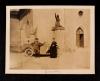 An AFS volunteer and a priest in front of the church where Joan of Arc had her first communion in...