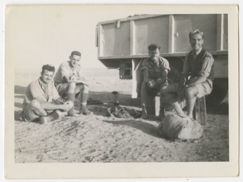 Trumbull Barton (far right) and three men sitting in front of a lorry